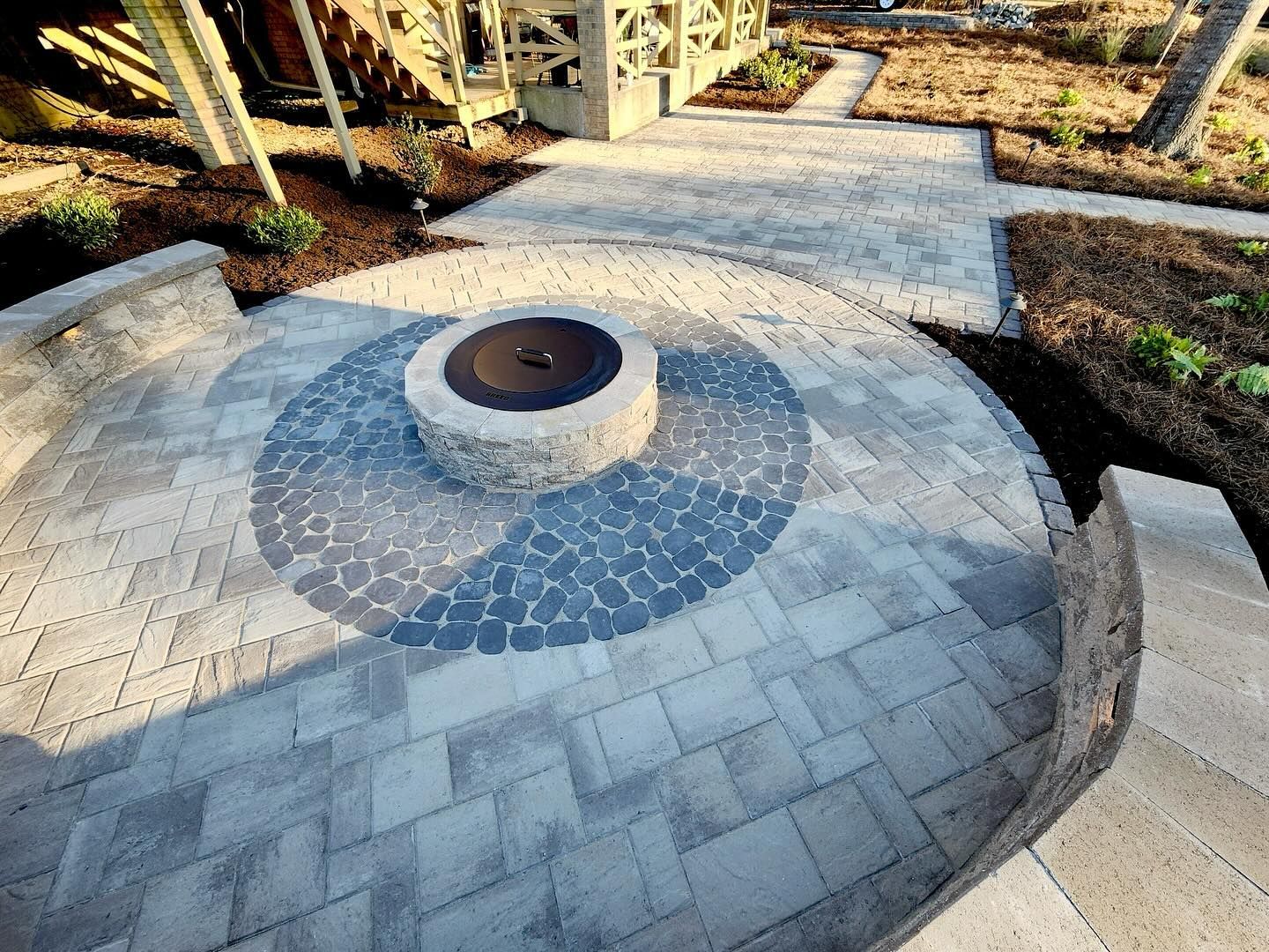 A fire pit in the middle of a circular patio