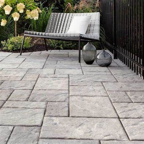 A patio with a chair and vases on it.