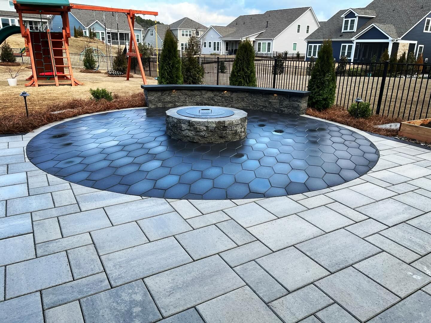 There is a fire pit in the middle of the patio.