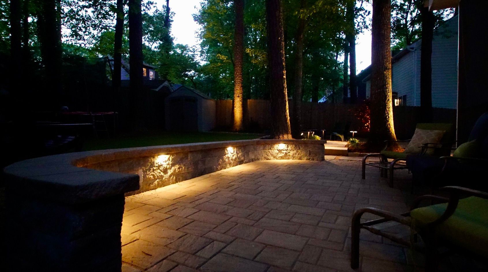 A brick patio with a fire pit in the middle of it