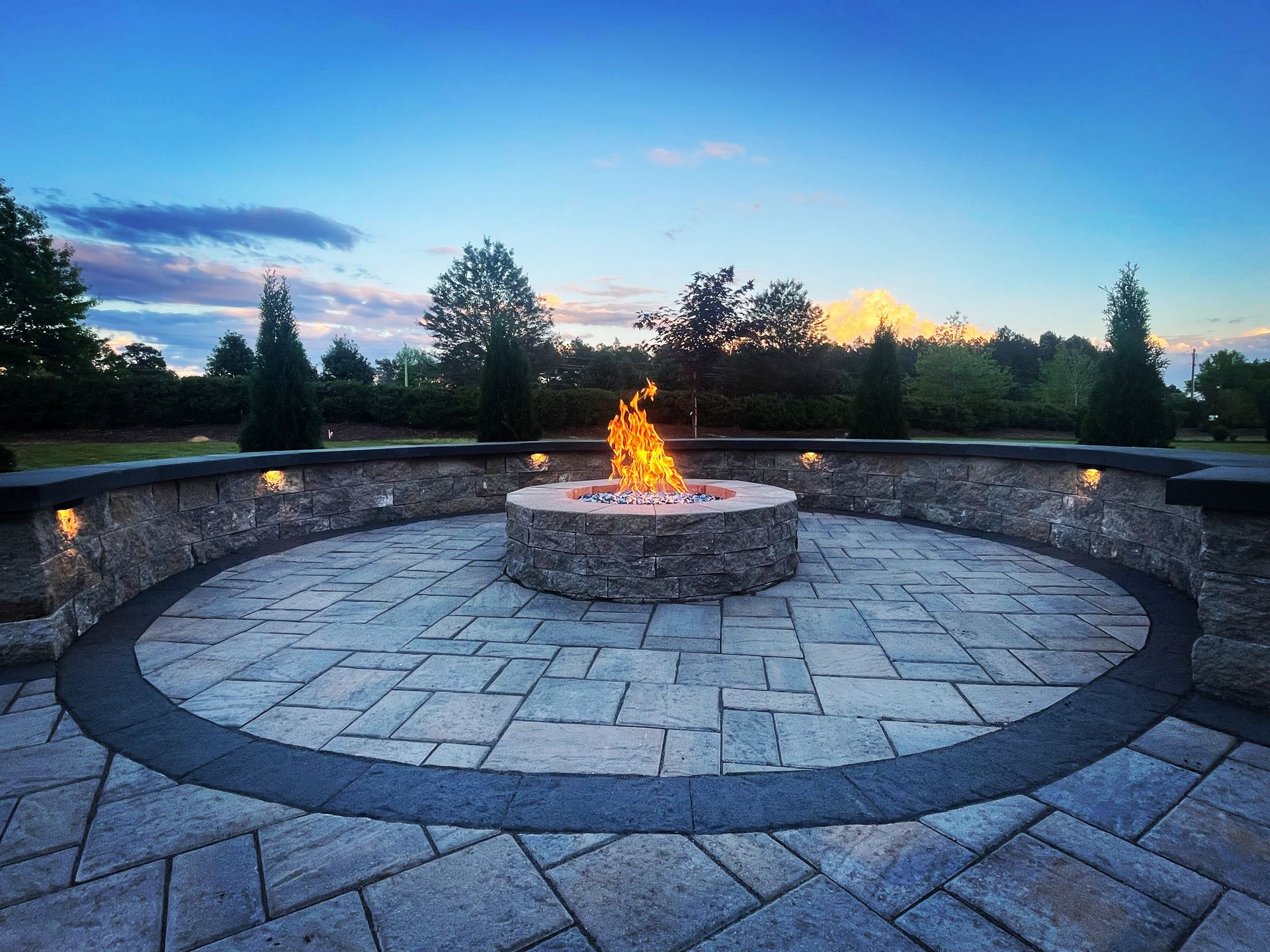 There is a fire pit in the middle of the patio.