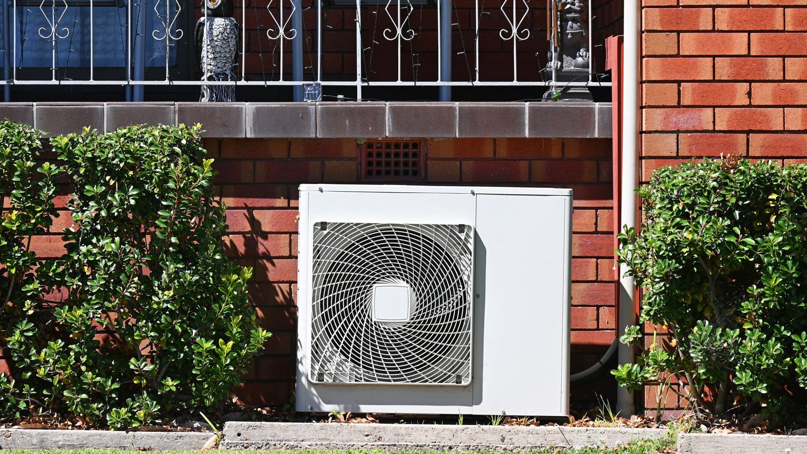 Installing an air conditioner unit indoors.
