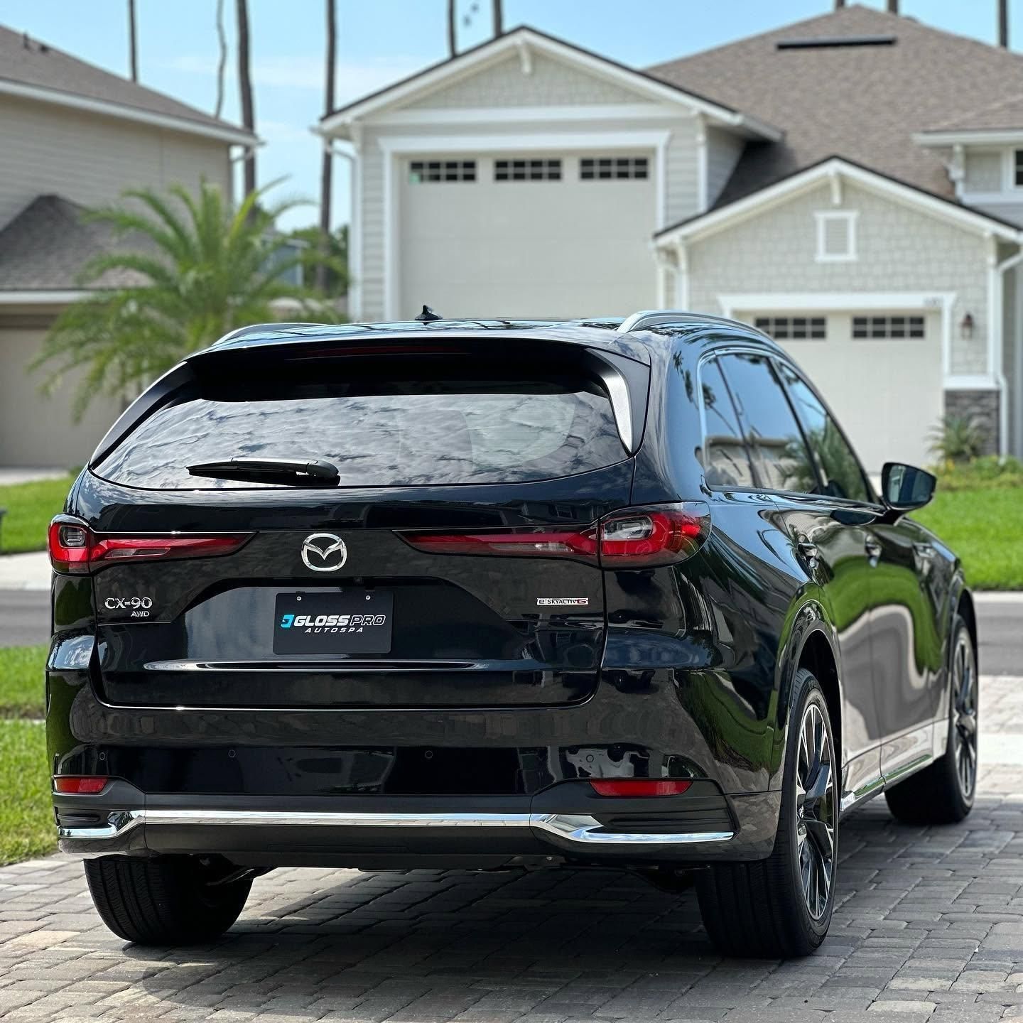 Silver Acura SUV parked in a garage, front view with headlights and grille visible