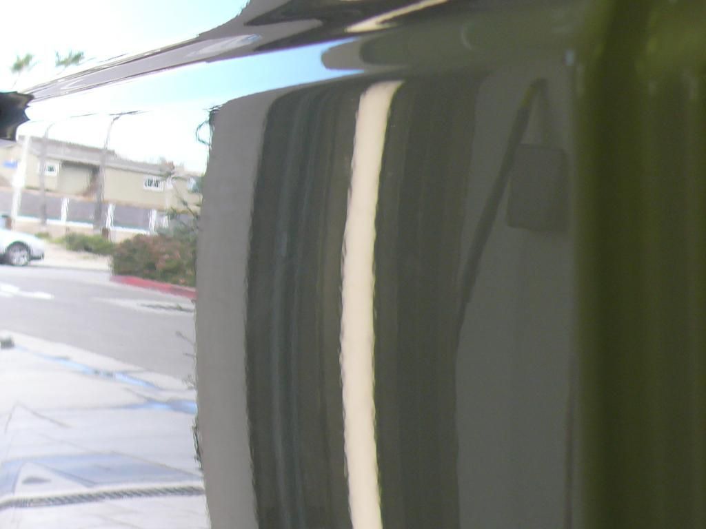 A close up of a car door with a white line on it