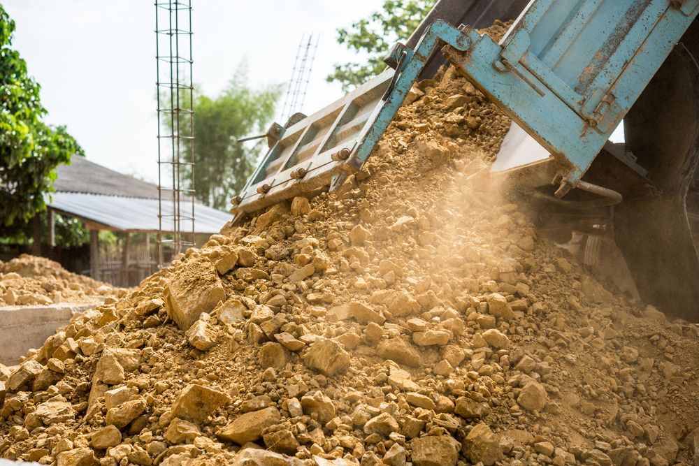 Truck Bed Dumping a Pile of Brown Soil — Jim Anderson Earthmoving Pty Ltd In Forster, NSW