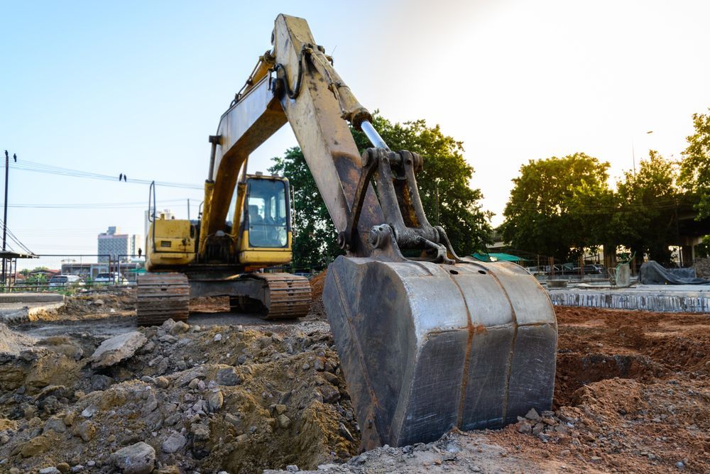 Yellow Excavator Digging in Dirt — Jim Anderson Earthmoving Pty Ltd In Laurieton, NSW