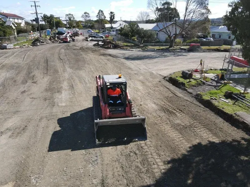 Red Skid Steer Operating on a Dirt Road — Jim Anderson Earthmoving Pty Ltd In Wingham, NSW