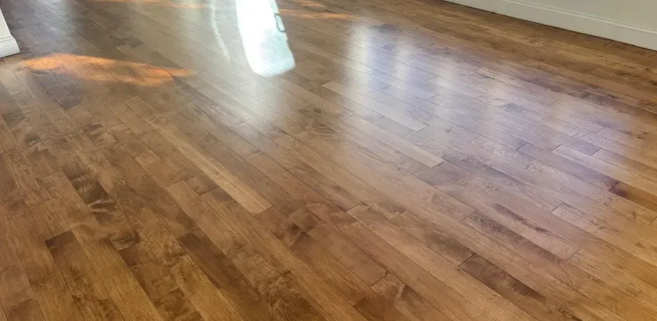 Polished wooden floor with bright light reflections