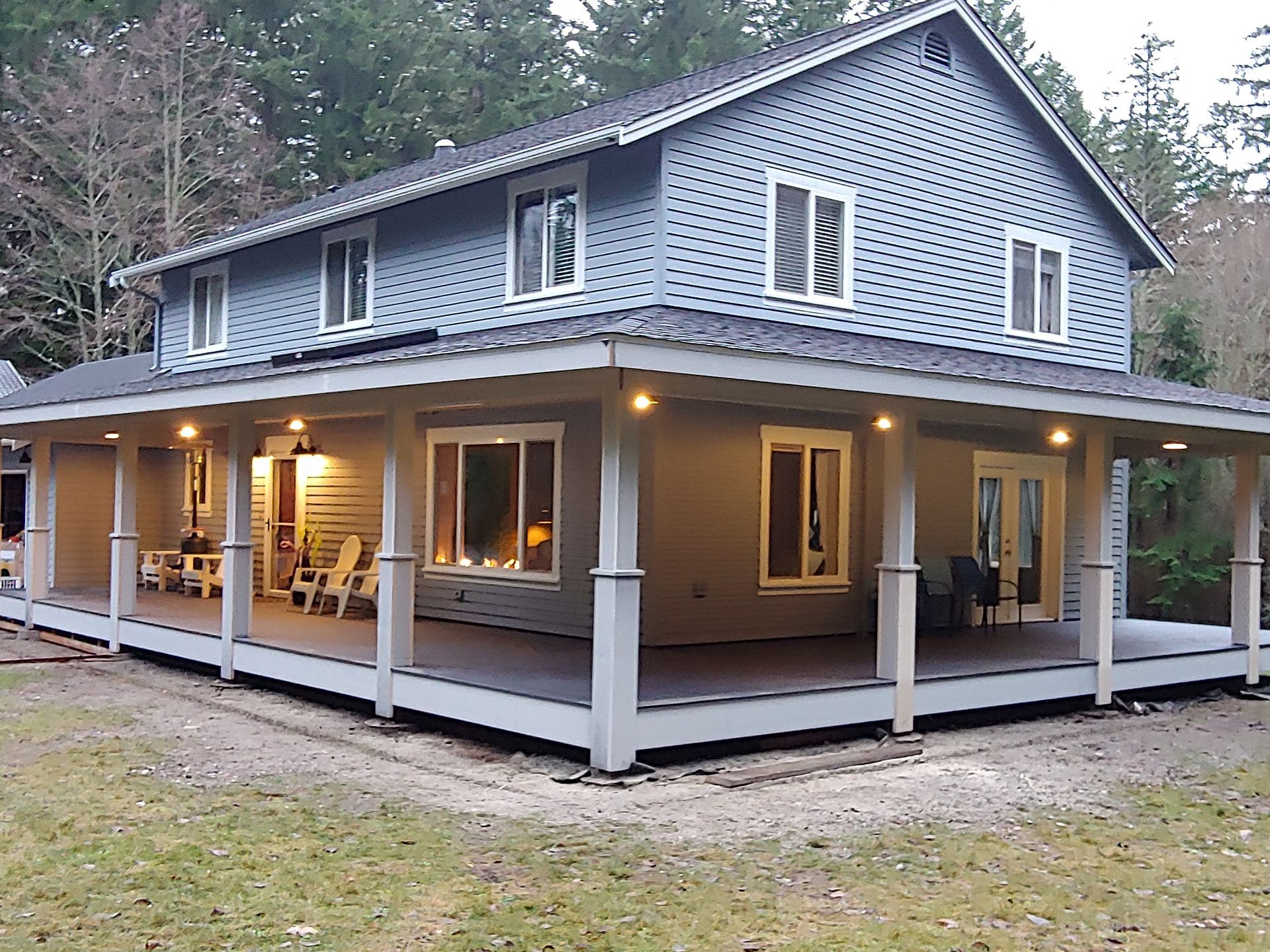 A large house with a large porch and a lot of windows