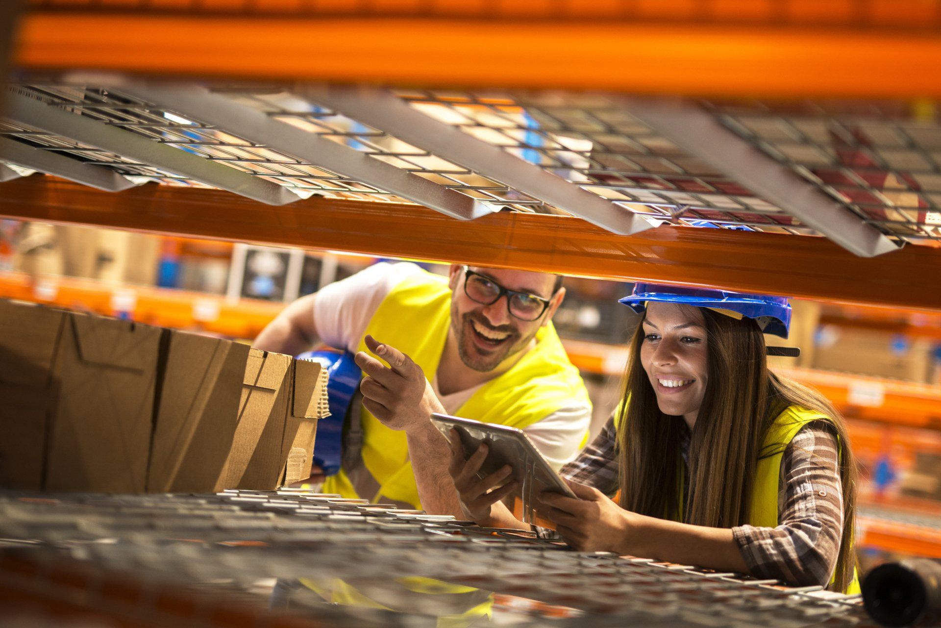 Trabajadores del almacén contando cajas en estantes en un gran almacén de distribución Trabajadores del almacén contando cajas en estantes en un gran almacén de distribución