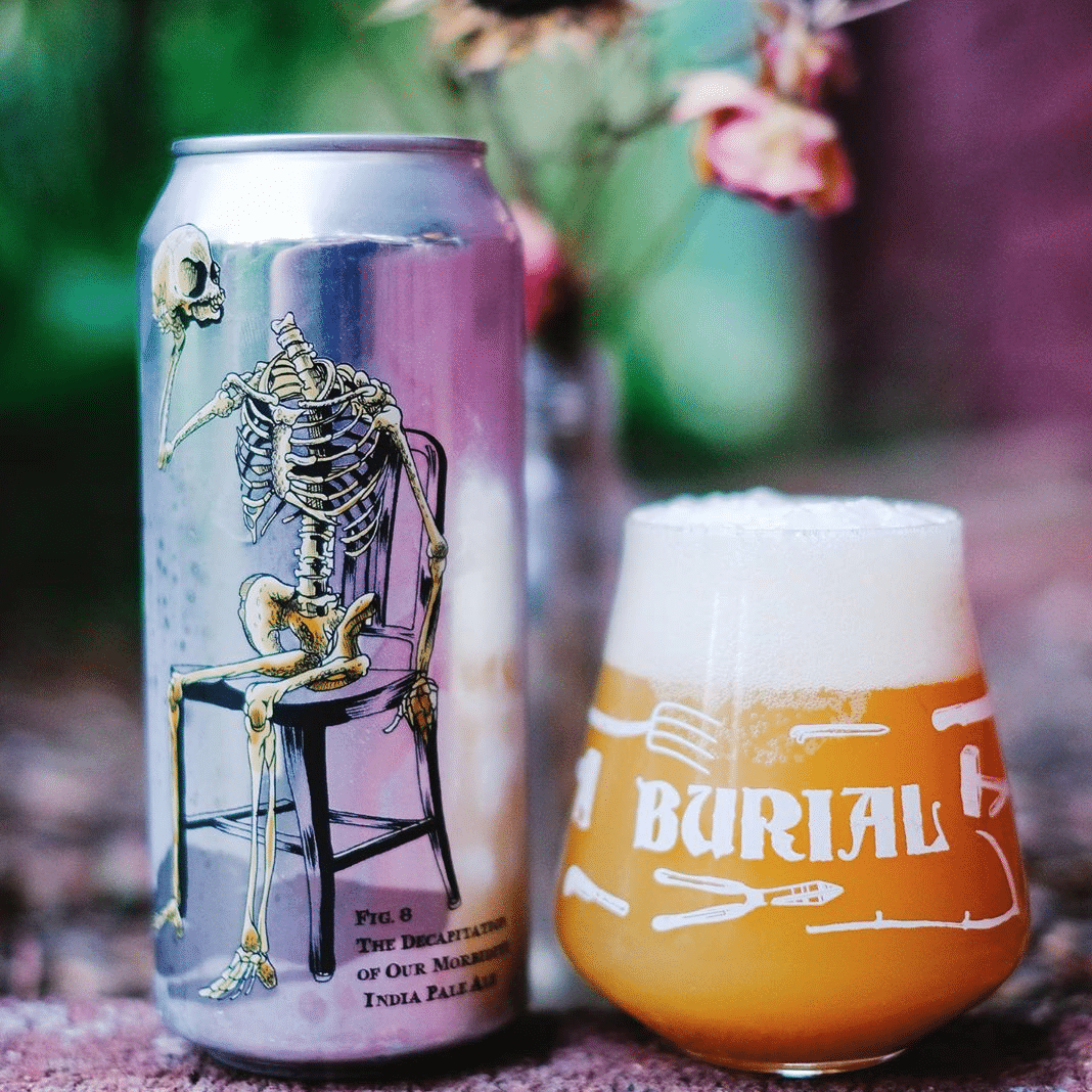 A beer can with a skeleton design next to a glass of beer, both branded 