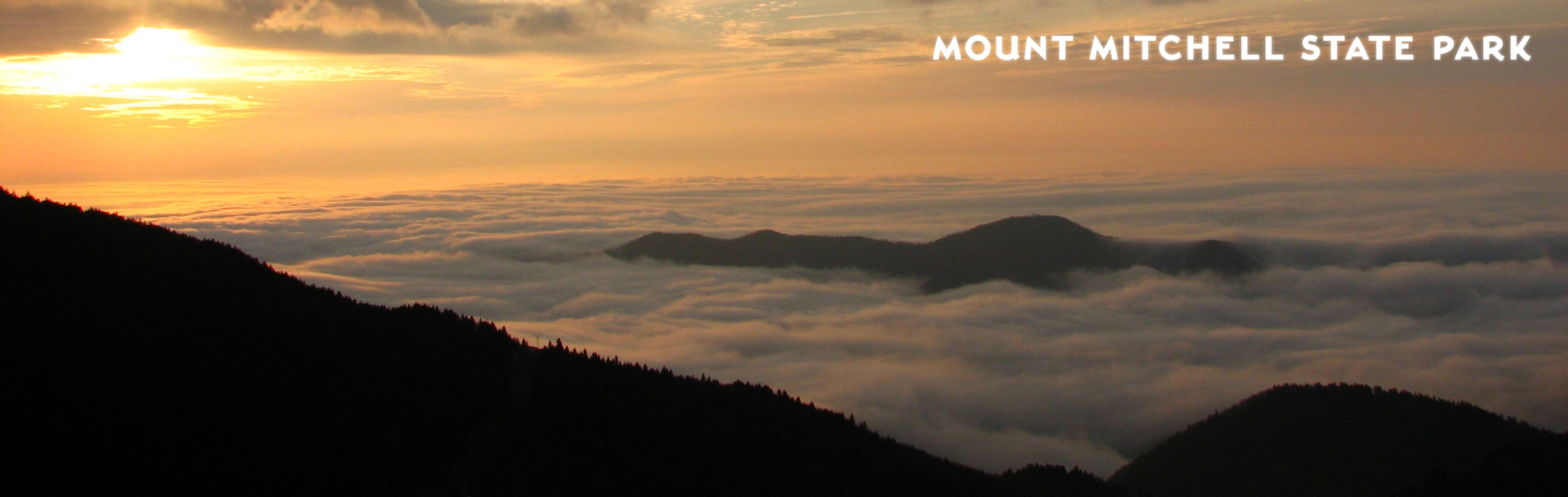 Mountaintops rise above a sea of clouds at sunset in Mount Mitchell State Park.