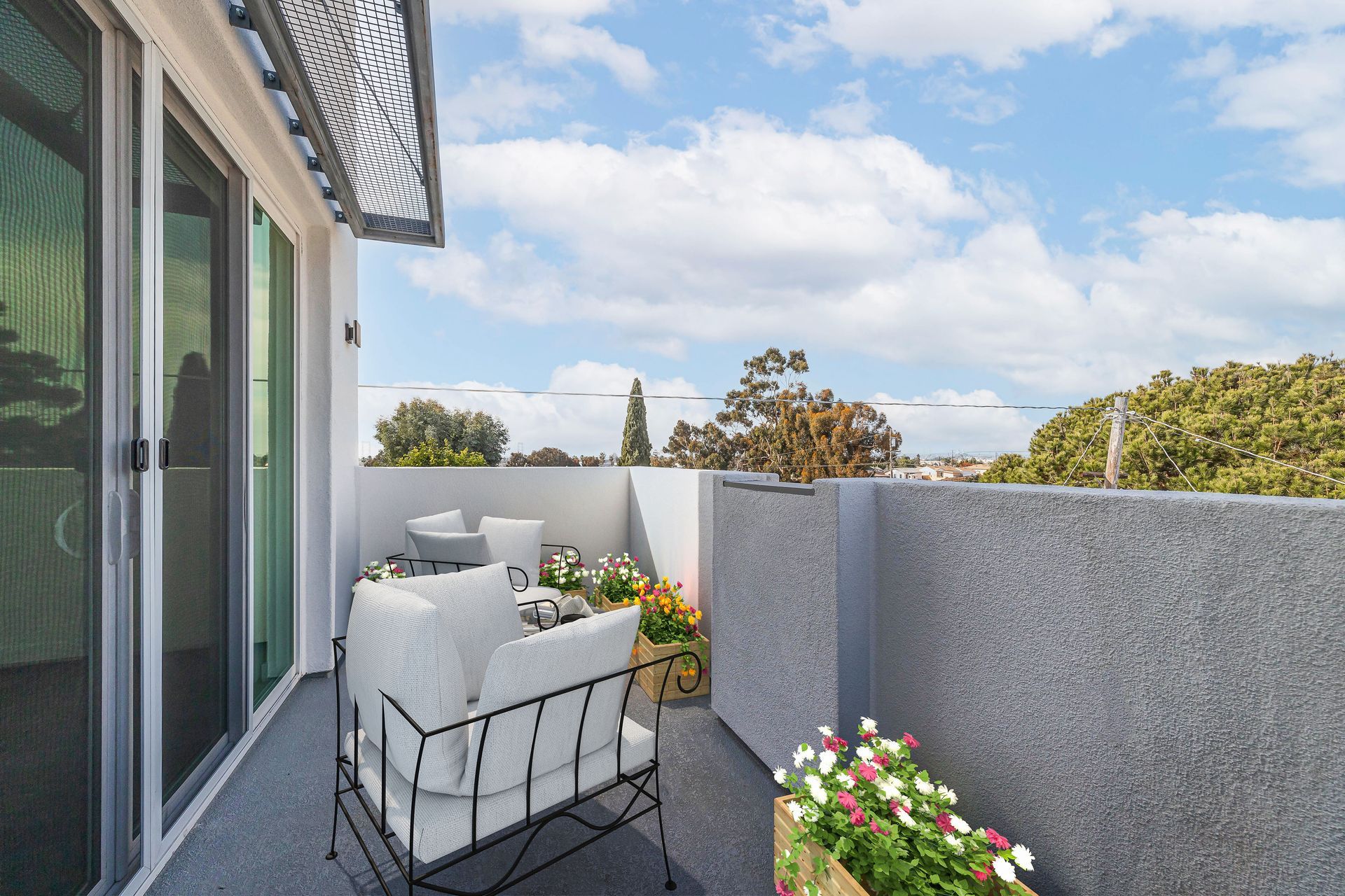 a balcony with a chair and a potted plant
