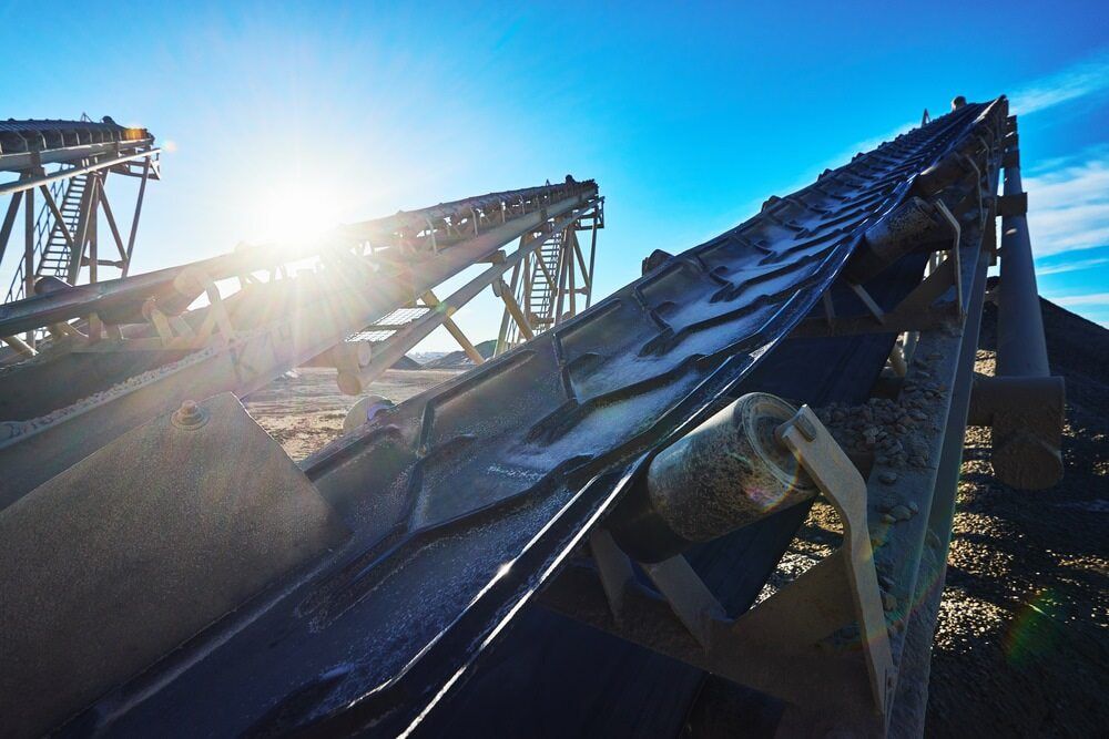 A Conveyor Belt in a Factory With the Sun Shining Through It — Himec Electrical In Withcott, QLD