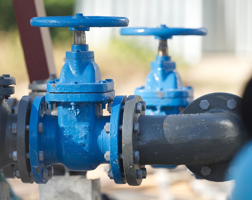 A Close Up of Two Blue Valves on a Pipe — Himec Electrical In Withcott, QLD