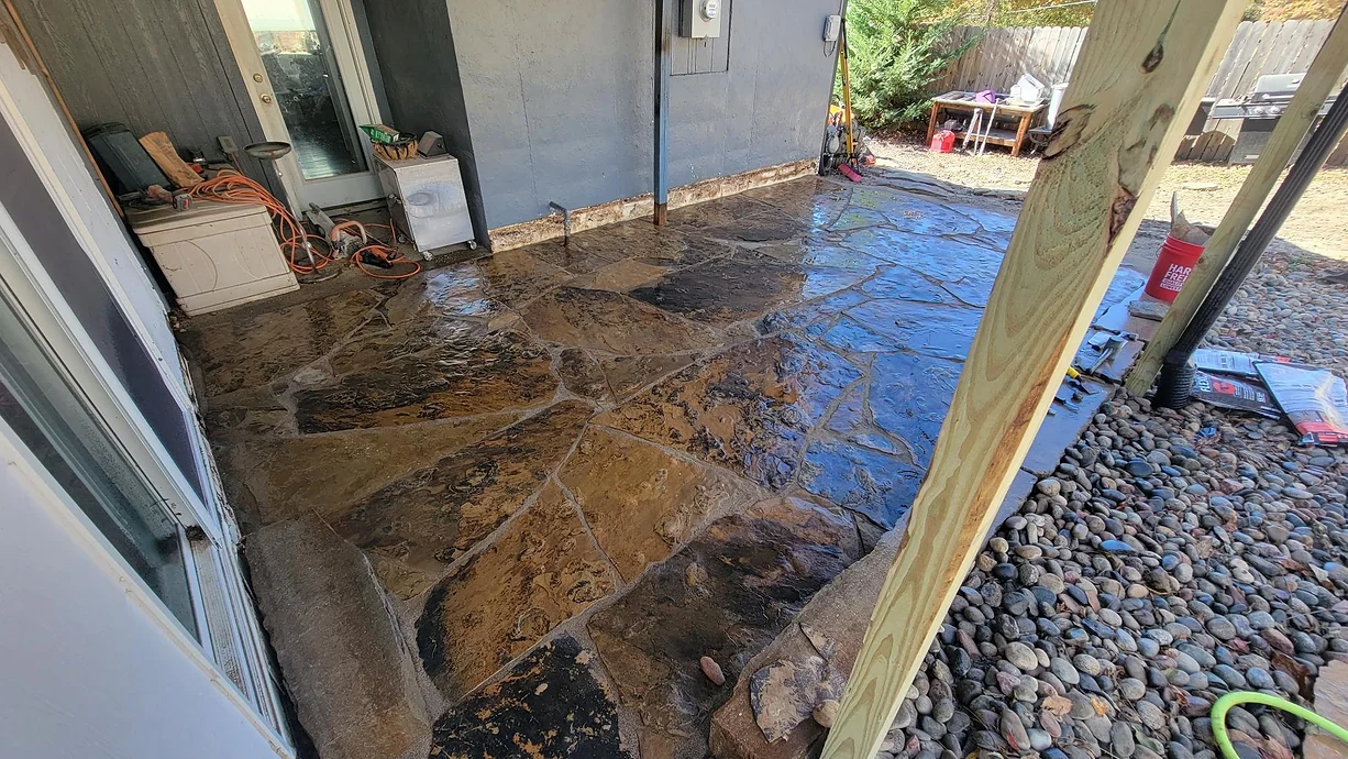 There is a lot of dirt on the ground in the backyard of a house.