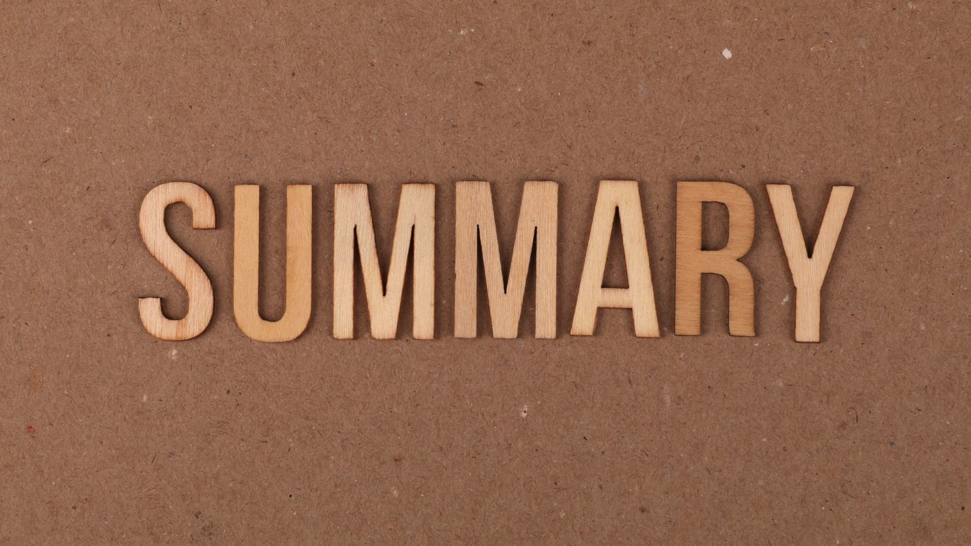 The word summary is written in wooden letters on a brown surface.