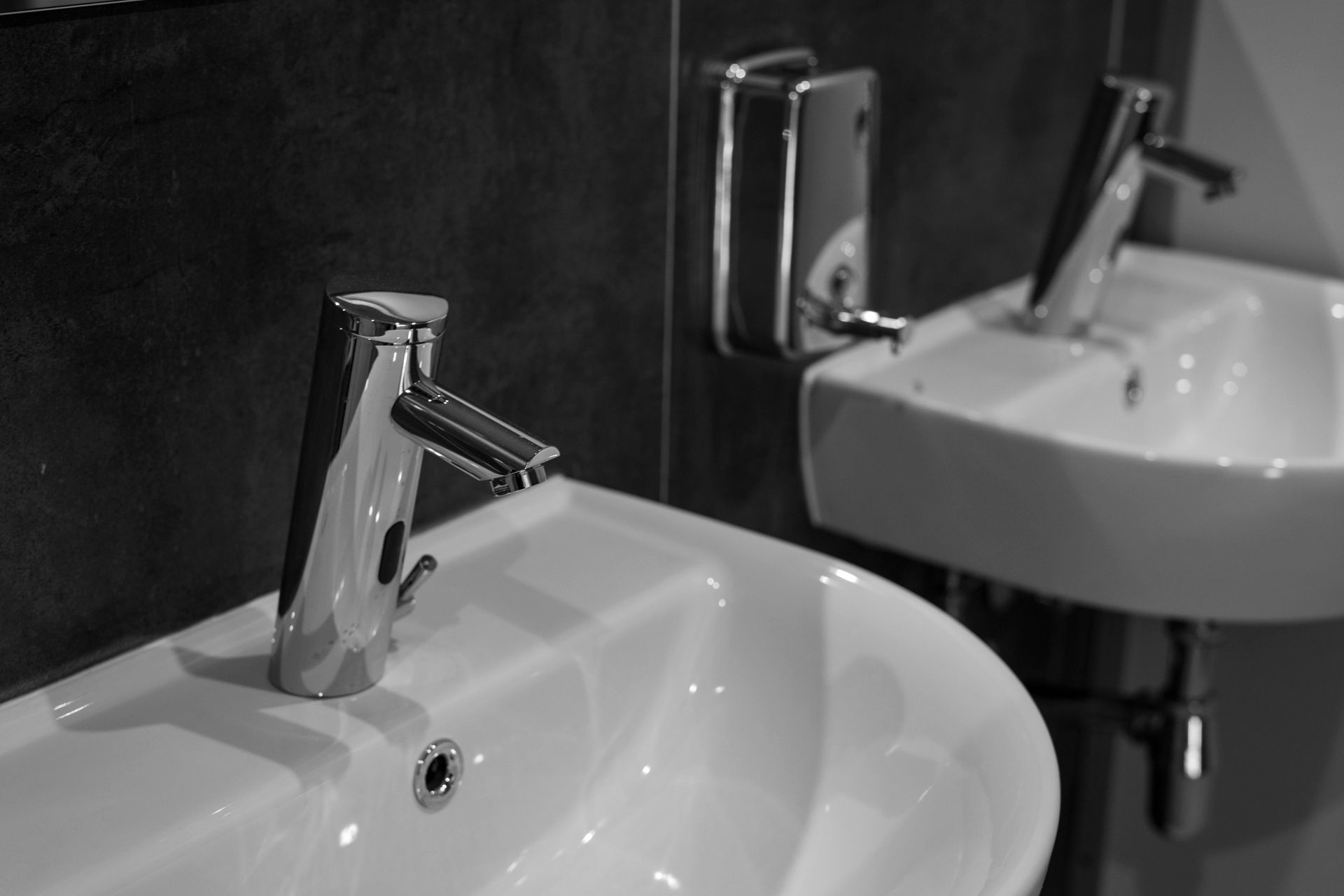 A black and white photo of two sinks in a bathroom