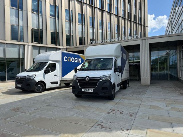 Two Coggin SOS vans parked outside an office building at the start of a clearance