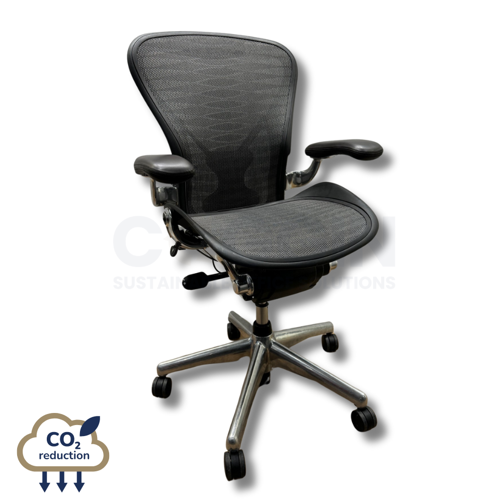 Black mesh ergonomic office chair with arms, labeled “CO2 reduction.”