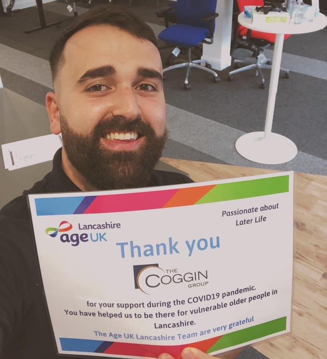 A member of the Coggin SOS team holding a thank you certificate from Age UK Lancashire for support during the COVID19 pandemic