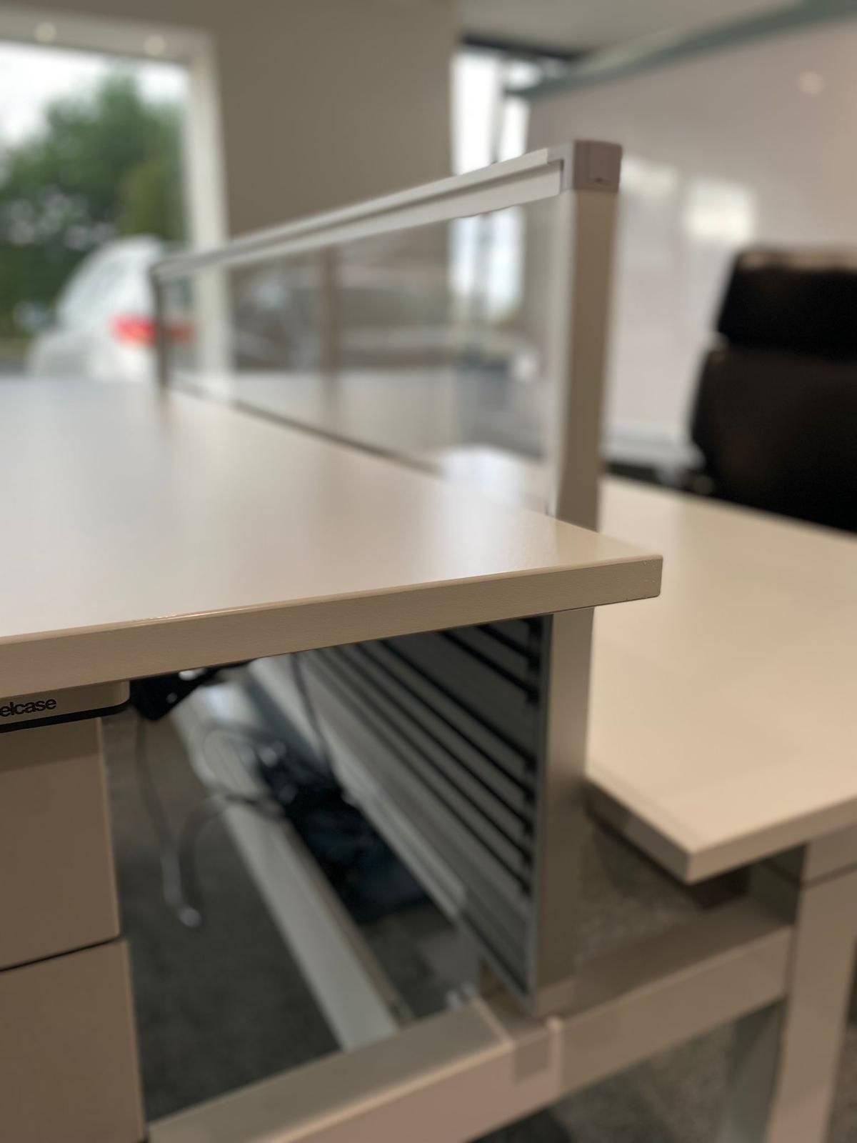 White office desk with a transparent divider.