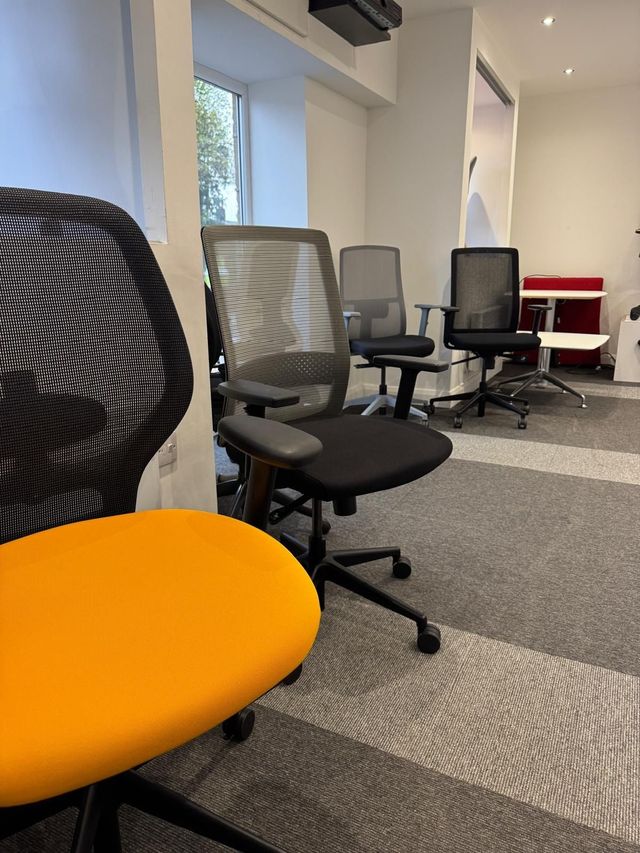 Refurbished mesh back task chairs lined up in a row
