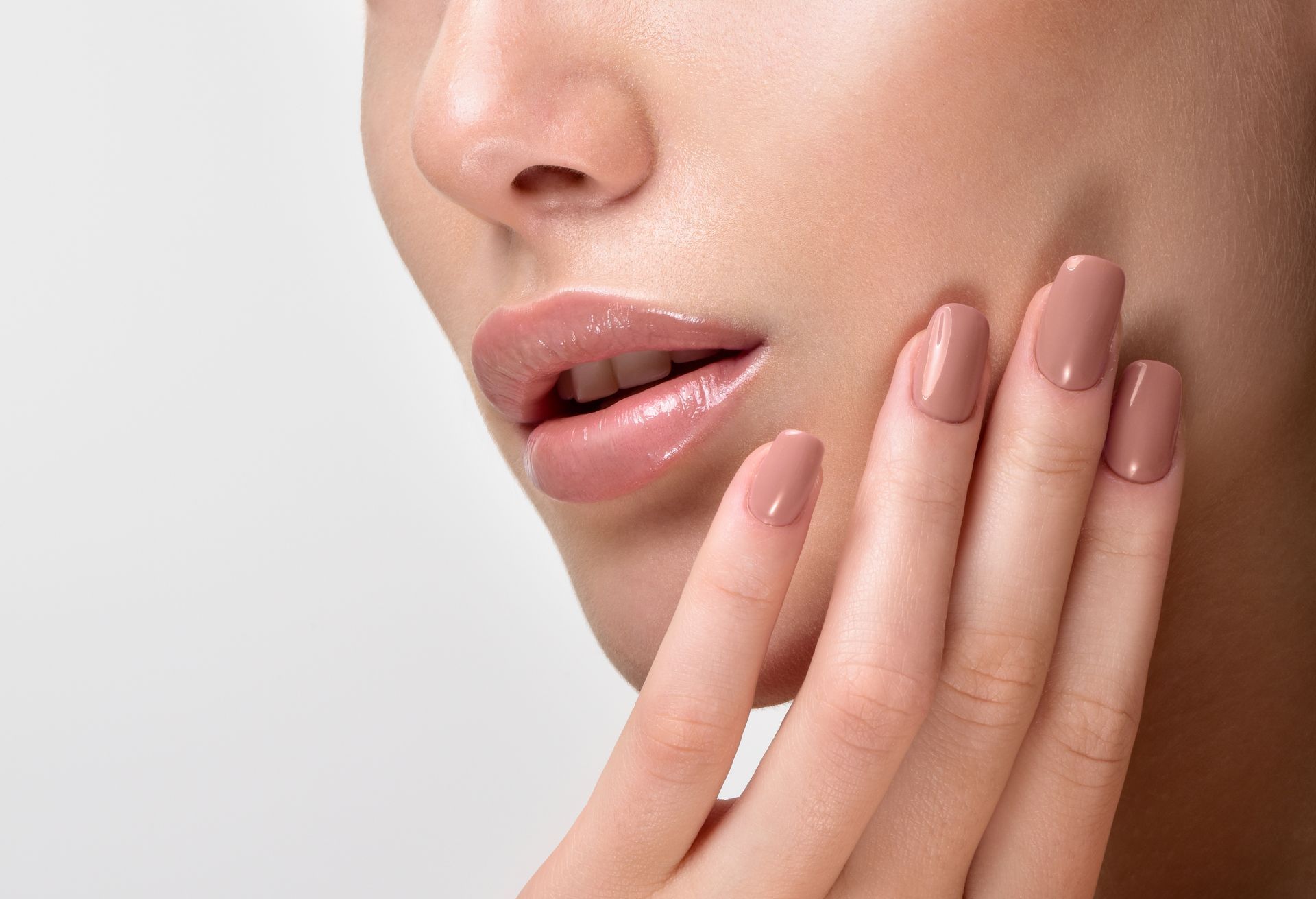 A close up of a woman 's face with her hands on it.