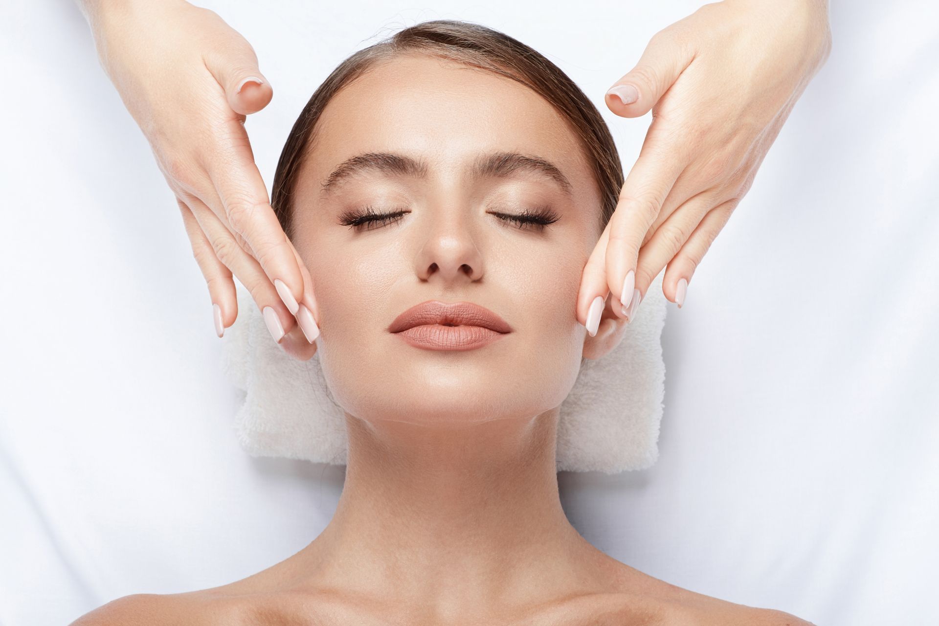 A woman is getting a facial treatment at a spa.