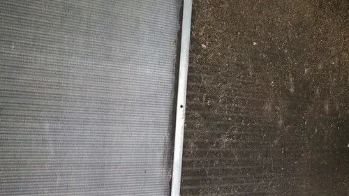 Close-up of two mesh screens divided by a white vertical bar, one light gray and one dark brown.