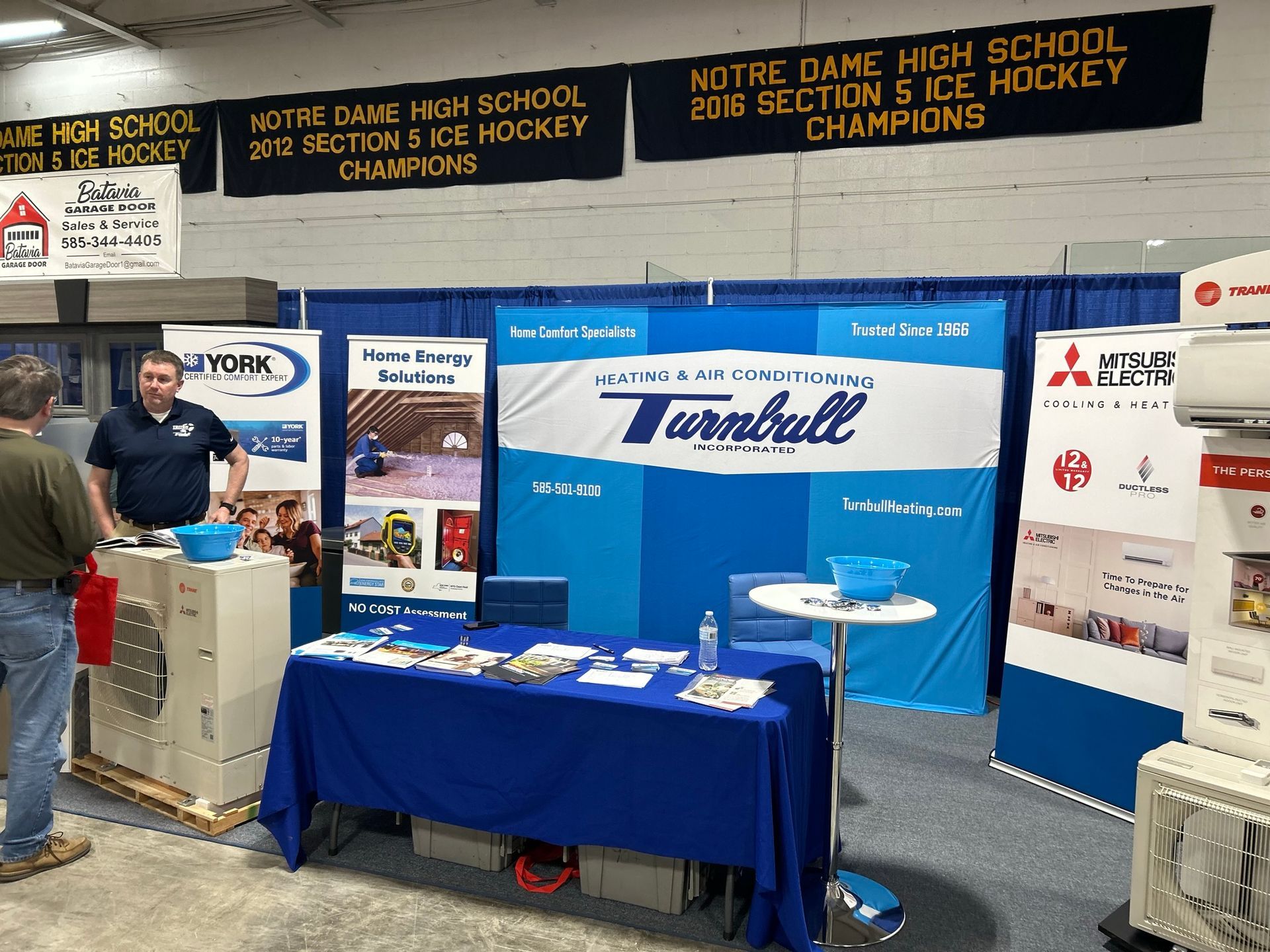 Trade show booth: Turnball HVAC display with representative talking to a visitor.
