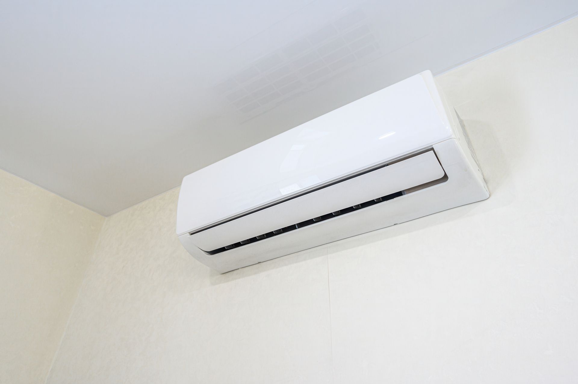 Sleek white wall-mounted air conditioner unit.