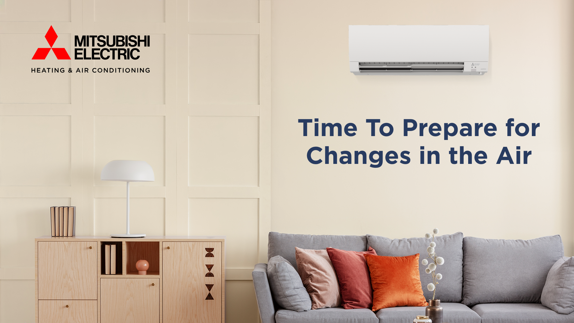 Mitsubishi Electric ad: Room with wall-mounted air conditioner, cabinet, couch, and text “Time To Prepare for Changes in the Air.”