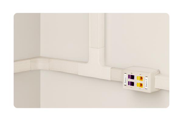 A white wall with a socket and a pipe on it.