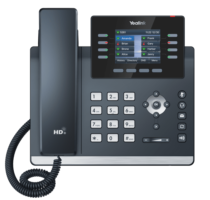 A yealink ip phone is sitting on a white surface.