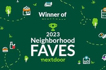 A green sign that says winner of neighborhood faves nextdoor