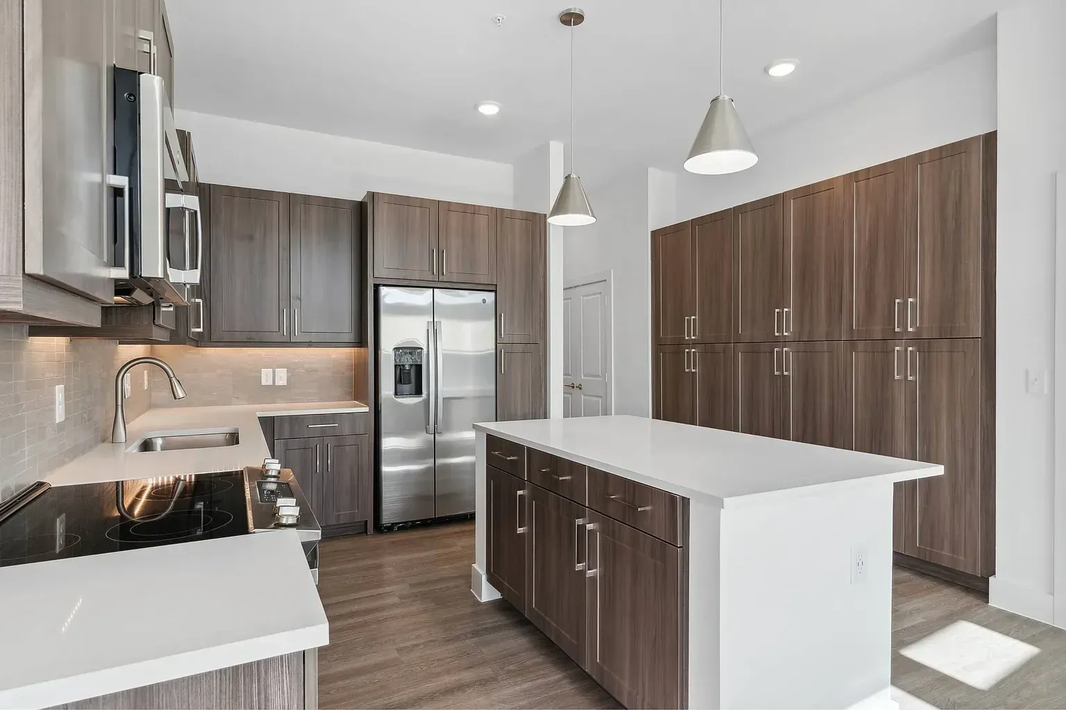 Modern kitchen with stainless steel appliances, island, and ample cabinet space.
