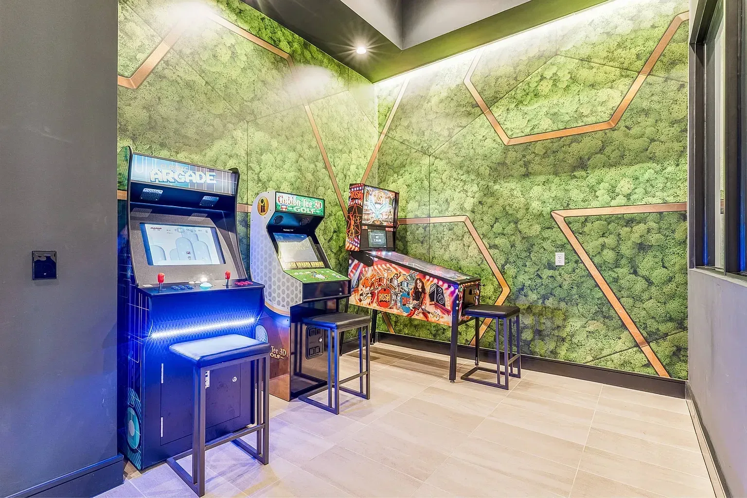 Arcade and pinball machines in a game room.
