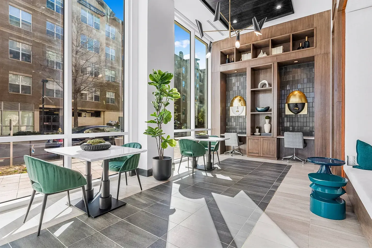 Modern coworking space with tables, chairs, and built-in shelving.