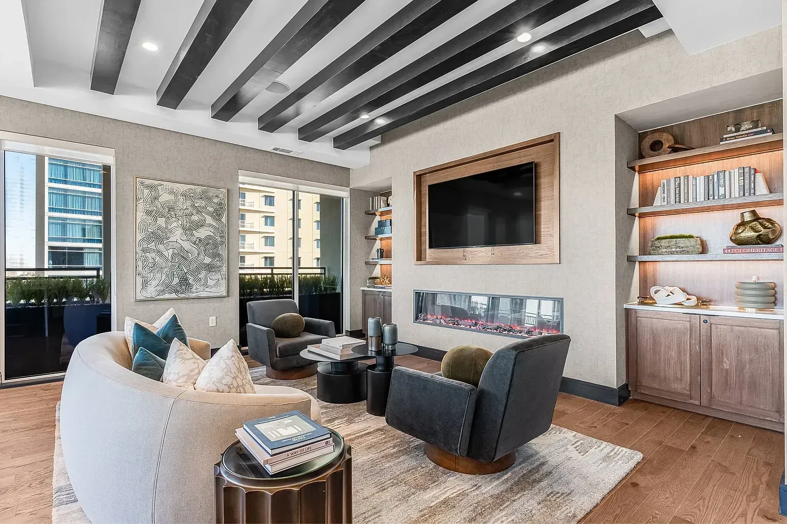 Modern living room with fireplace, TV, and balcony view.