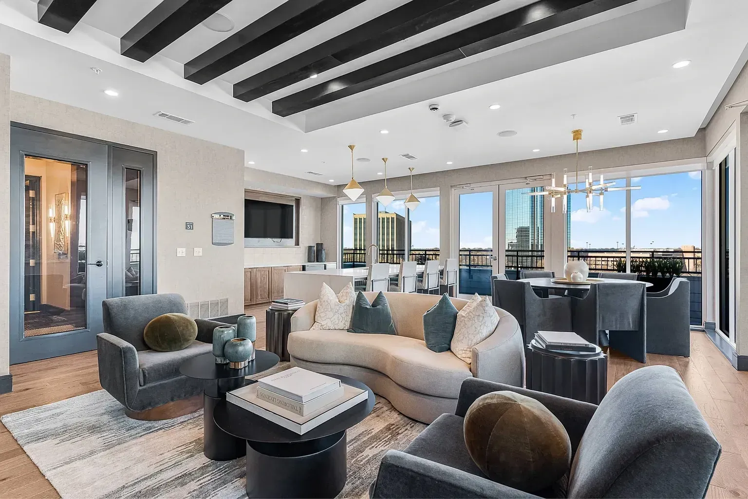 Stylish lounge area with plush seating, coffee tables, and city views.