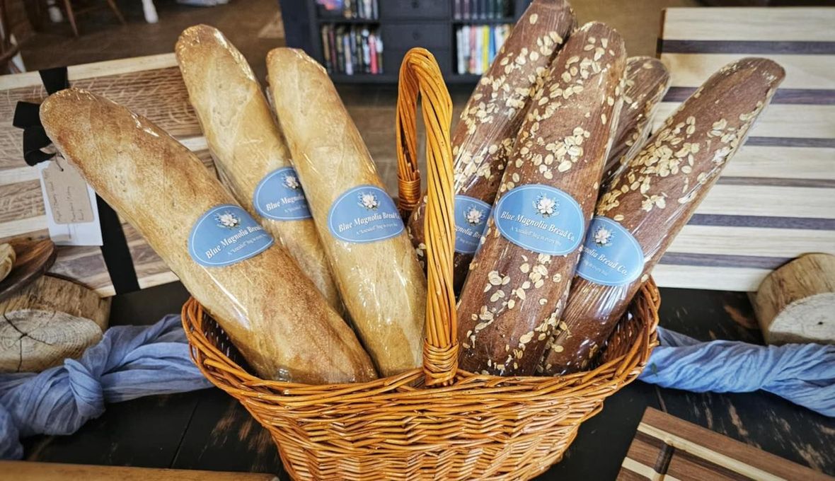 A basket filled with bread sticks on a table.