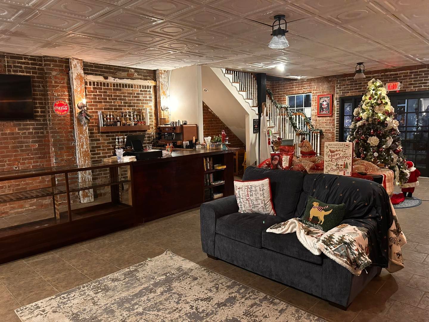 A living room filled with furniture and a christmas tree.