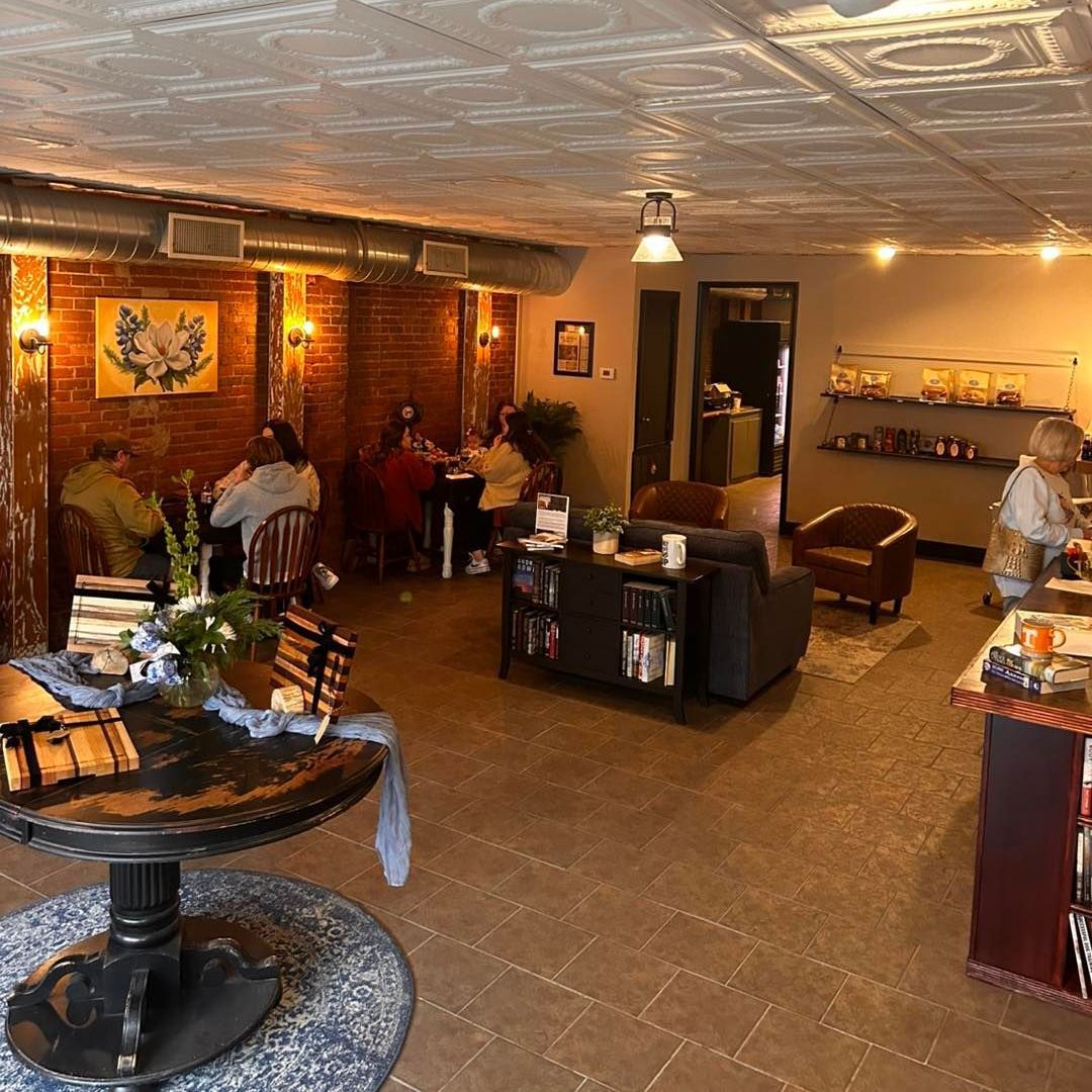 A restaurant with people sitting at tables and chairs