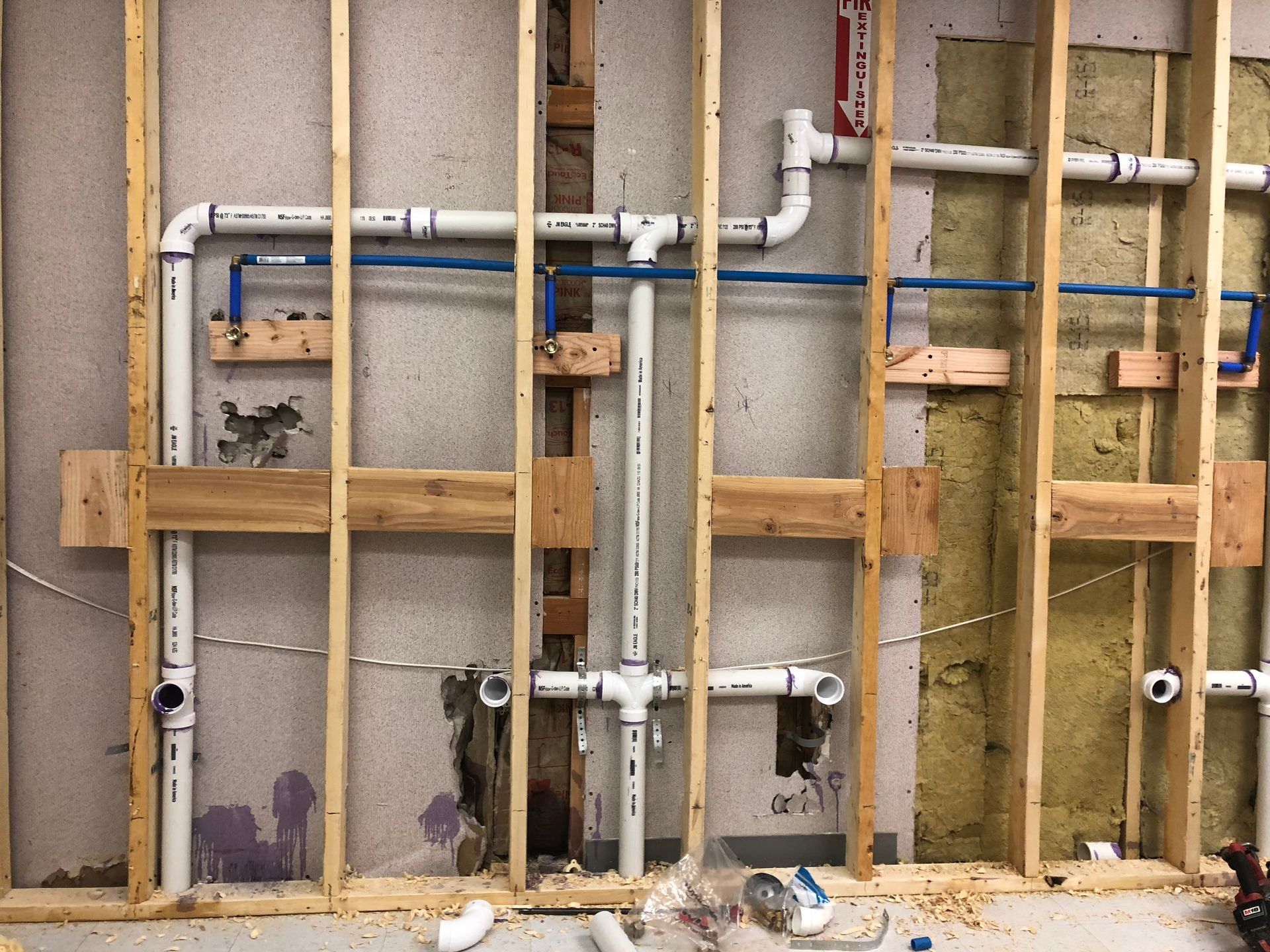 A wall with a lot of pipes coming out of it