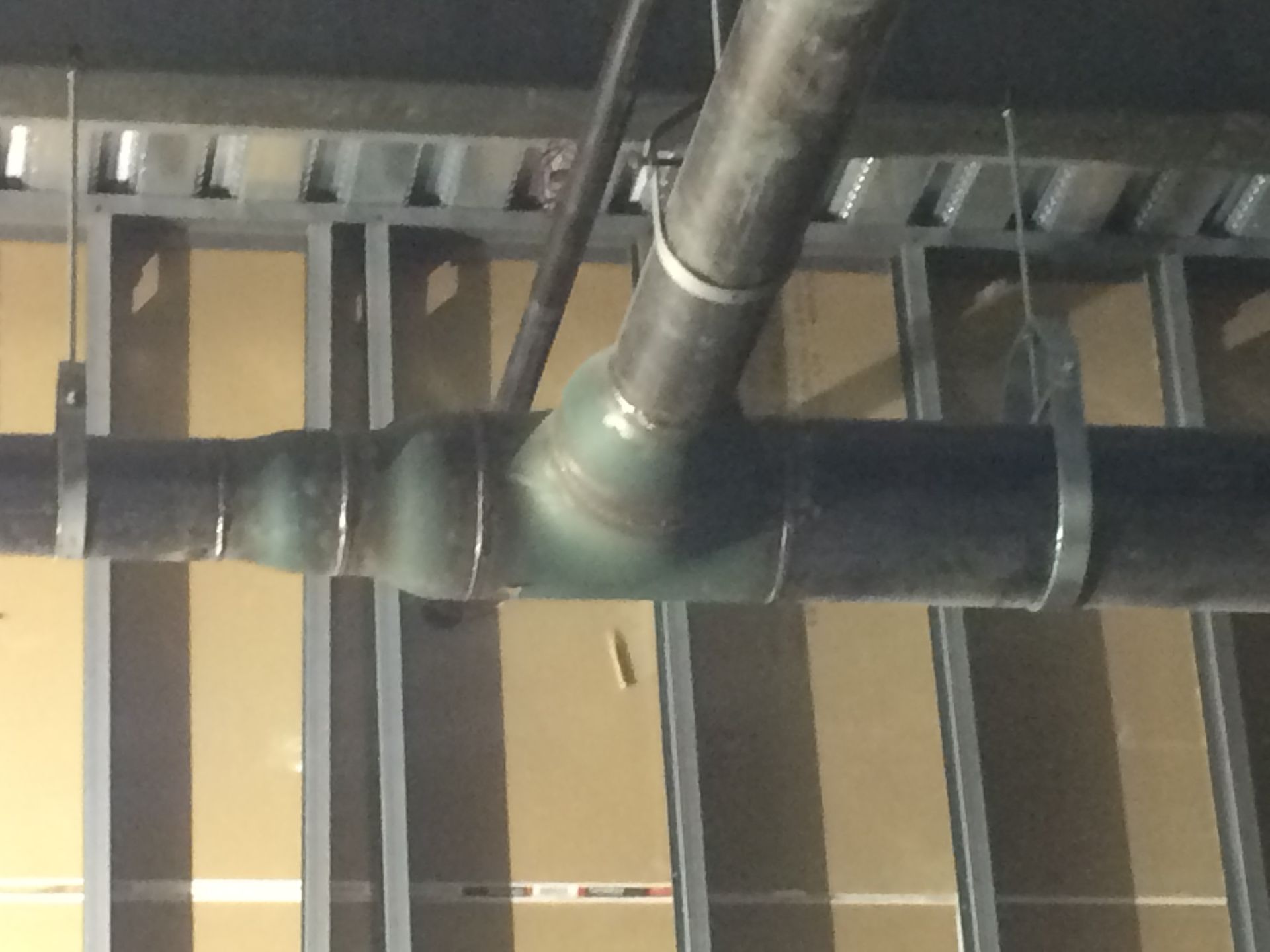 A pipe is hanging from the ceiling of a building