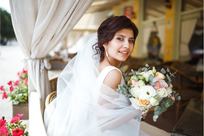 photo of a women at a wedding dressed in wedding clothes with photo booth photo in new york
