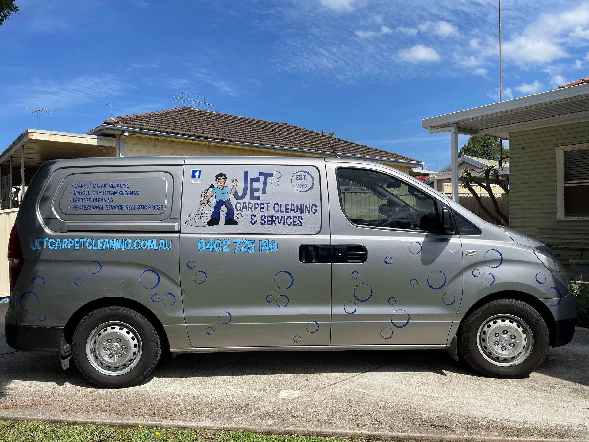 Silver van for carpet cleaning and services parked on a driveway.