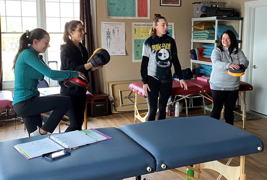 A Woman Having a Massage with a Flower in Her Hair — Grafton, WI — Blue Sky School of Professional Massage & Therapeutic Bodywork A Woman Having a Massage with a Flower in Her Hair — Grafton, WI — Blue Sky School of Professional Massage & Therapeutic Bodywork