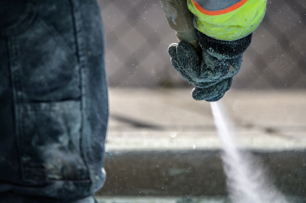A Person is Sandblasting a Concrete Surface — Hastings Valley Powdercoaters in Harrington, NSW